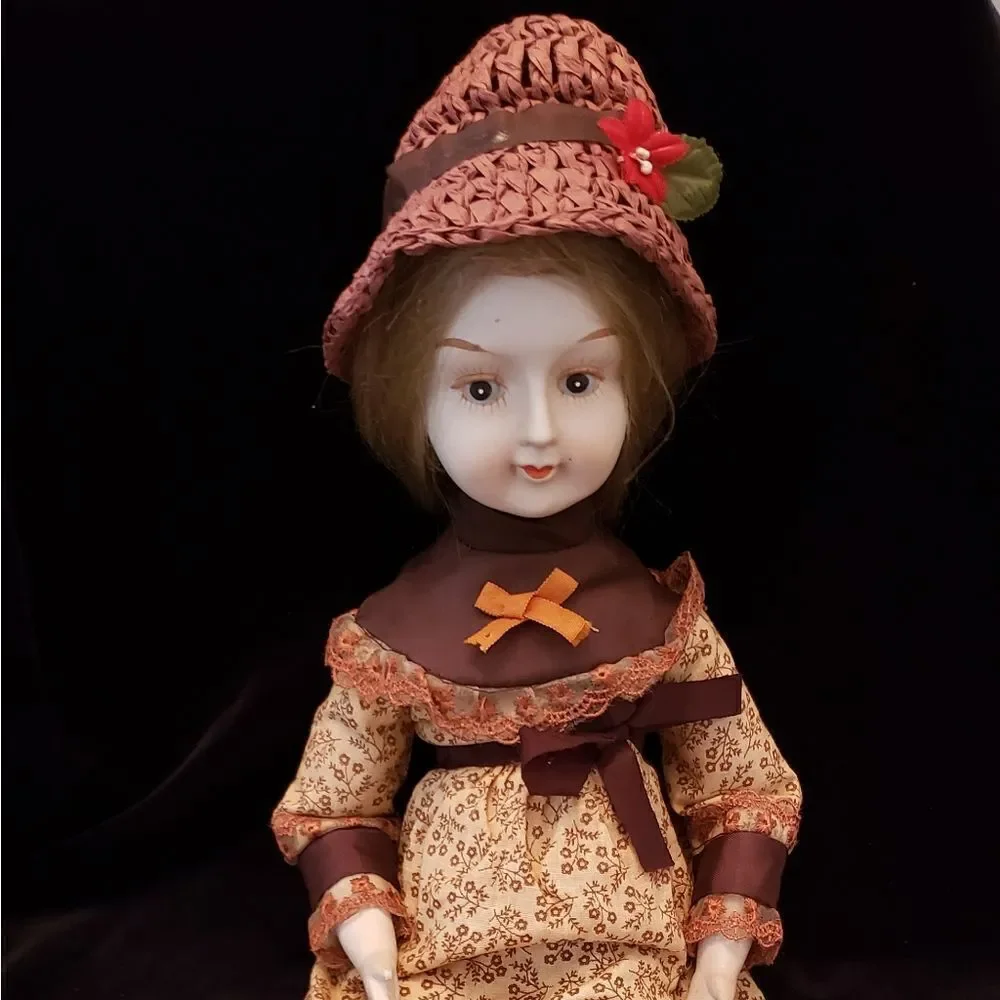Vintage Porcelain Doll with Brown Dress and Hat